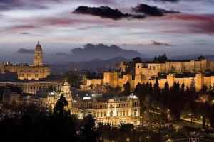 a view of a city at night with a building at Paseo Maritimo de Poniente in Málaga