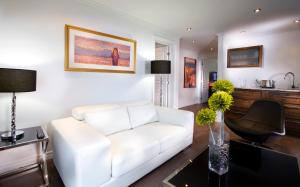 a living room with a white couch and a table at Riotel Perce in Perce