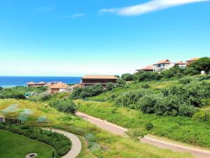 a winding road on a hill next to the ocean at Zimbali Suite 311 in Ballito