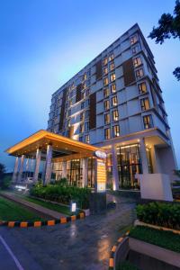 a large building with a lot of windows at Harper Cikarang by ASTON in Cikarang