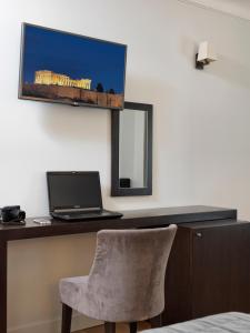 a desk with a chair and a computer on it at Acropolis Hill Hotel in Athens