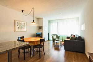 a living room and dining room with a table and chairs at Appartementhaus-Quadern in Valens