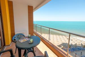 balcón con mesa, sillas y vistas al océano en Apartment complex Mirage of Nessebar, en Nesebar