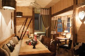 a living room with a couch and a table at The Originals Boutique, Hôtel La Ferme du Pape, Eguisheim in Eguisheim +25 photos
