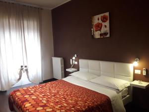 a bedroom with a large bed and a window at Dolci Ricordi in Bari