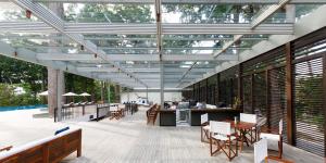 a patio with tables and chairs and a pool at Taj Exotica Resort & Spa, Andamans in Havelock Island