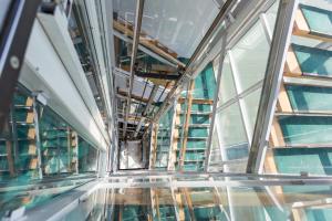 a hallway in a building with glass windows at Classic Hotel in Budapest