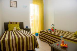 a bedroom with two beds with stuffed animals on them at Les Maisons du Golf d'Armagnac in Eauze