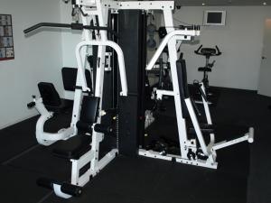 a gym with two tread machines and two chairs at ACD Apartments in Melbourne