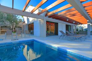 a house with a swimming pool and a patio at Villa Tapenade in Lastovo
