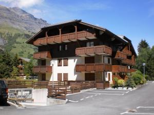 a large building with wooden balconies on a mountain at Location Montagne in Les Contamines-Montjoie