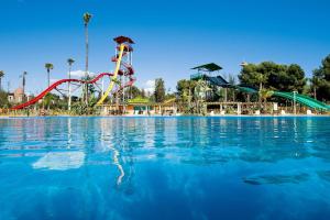 a large pool with a water park with slides at apartamento Kottmann in Cambrils