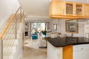 a kitchen with a counter top and a living room at WATERFRONT - Quay Largo two bedroom on the water with mooring in Knysna