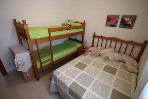 a childs bedroom with two bunk beds at apartamento Kottmann in Cambrils +25 photos