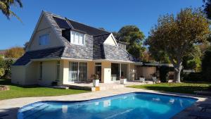 una casa con piscina delante de una casa en Villa Karibu, en Tokai