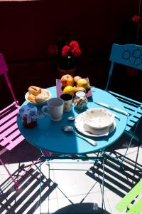 a blue table with a plate of food on it at La Maison de Thaïs in Arles