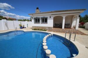 a swimming pool in front of a house at Villa Dorada in Montroig