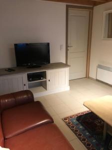 a living room with a couch and a flat screen tv at Zeepark Mercator in Molenwijk