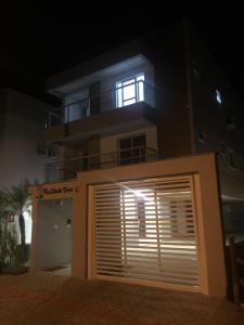 a building with a garage door in front of it at night at Lindo AP Maravilhosa Praia Palmas in Governador Celso Ramos
