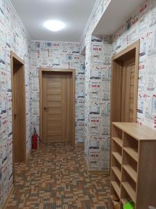 a room with a wall covered in paper at Hostel 888 У Вокзала in Novosibirsk