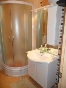 a bathroom with a sink and a shower at Apartmani Tomičić in Malinska