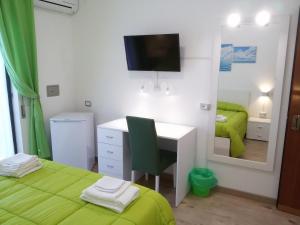 a bedroom with a desk and a mirror at Hotel Elizabeth - Soverato in Soverato Marina