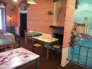 a restaurant with two tables and a fireplace at Racconti di Mare - 5 Terre JRE in La Spezia