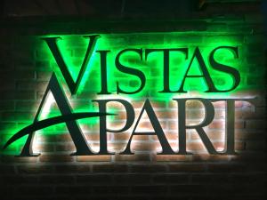 a neon sign that says vests a party on a brick wall at Vistas Apart in Embalse