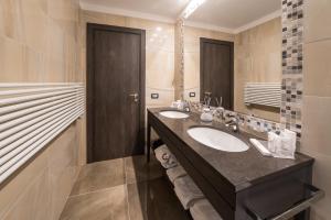 a bathroom with two sinks and a large mirror at Hotel Guerro in Castelvetro di Modena +58 photos