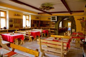 an empty restaurant with red tables and chairs at Три Брати in Grebenov