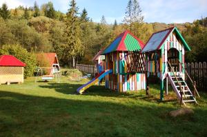 a colorful playground with a slide in a yard at Три Брати in Grebenov