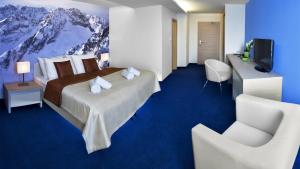 Posteľ alebo postele v izbe v ubytovaní Hotel Slovan