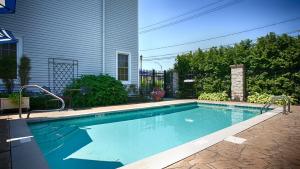 a swimming pool in front of a house at Best Western Plus Mentor-Cleveland Northeast in Mentor