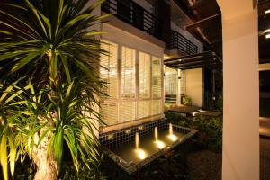 a row of candles in a courtyard at night at Napatra Hotel in Chiang Mai