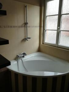 a bath tub in a bathroom with a window at Home sweet Home in Homburg +20 photos