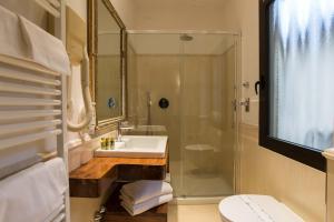 a bathroom with a shower and a sink and a toilet at Hotel Atlantic Palace in Florence