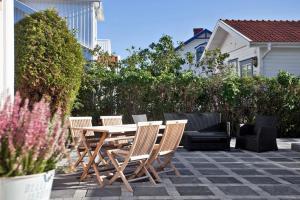 a patio with a table and chairs and a couch at Hotell & Restaurant Solliden in Stenungsund