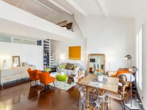 マルセイユにあるWelkeys Apartment - Sainteのリビングルーム(テーブル、オレンジチェア付)