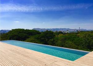 a swimming pool sitting on top of a wooden deck at Inchantreedoopool in Kanchanaburi City