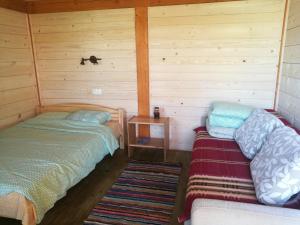 a room with two beds and a table in it at Rozītes in Cesvaine
