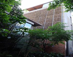 a brick building with a window on the side of it at Inchantreedoopool in Kanchanaburi City