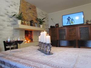 a dining room with a table with candles and a fireplace at Bavaria House in Govedartsi