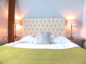 Una cama blanca con una almohada encima. en Hotel Rezydencja Solei, en Poznan