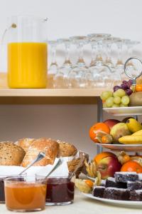 a table topped with lots of different types of food at Hotel am Rokokogarten in Veitshöchheim