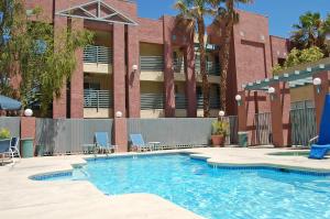a swimming pool in front of a building at Extended Stay America Suites - Las Vegas - Valley View in Las Vegas