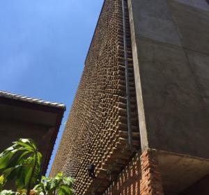 a tall brick tower on the side of a building at Inchantreedoopool in Kanchanaburi City