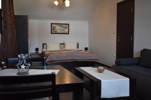 a living room with a couch and a bed at Bavaria House in Govedartsi