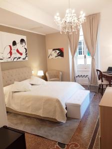a bedroom with a large bed and a chandelier at VarazzeSuite Sauna e Hammam in Varazze +75 photos