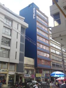 a blue building in the middle of a city at Hotel Manila Plaza in Bogotá