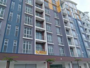 a large apartment building with many windows at NAUFAL MUSLIM'S HOMESTAY in Cameron Highlands